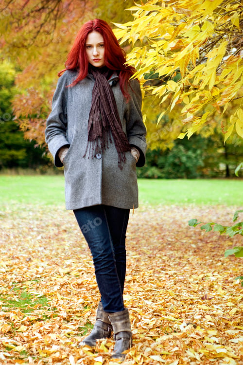 Preview: A Young Woman Standing Next To A Tree In Autumn Time