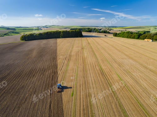 Preview: Aerial View Of Tractor Ploughing In Farm Field