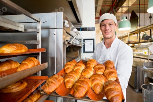 Preview: Wide Shot Of A Smiling Baker Placing Freshly Baked Breads In The Rack