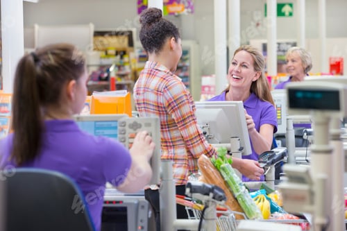 Preview: Woman Paying For Shopping At Supermarket Checkout