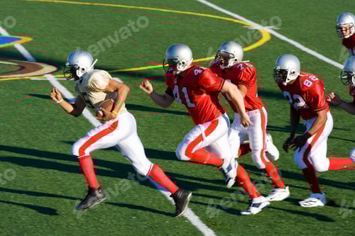 Preview: Football Players Running on the Field During the Day