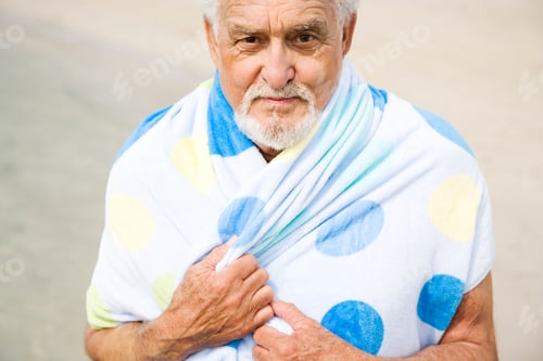 Preview: Portrait Of A Senior Man Wrapped In A Towel At The Beach