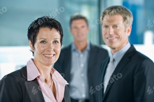 Preview: A Businesswoman With Two Male Colleagues In The Background