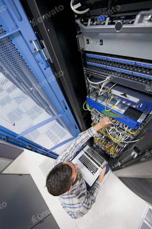 Preview: Top Angle Shot Of A Technician Holding A Laptop And Checking The Server