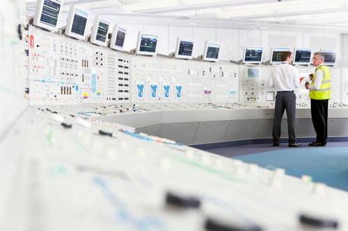 Preview: Wide Shot Of A Senior Engineer In A Reflector Vest Speaking To A Young Engineer In The Control Room