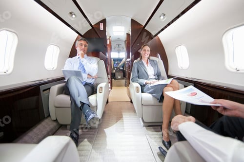 Preview: A Businessman And A Businesswoman Sitting In A Private Jet