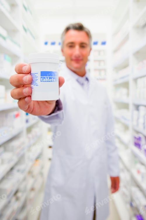 Preview: Pharmacist Holding Bottle Of Prescription Medication In Pharmacy