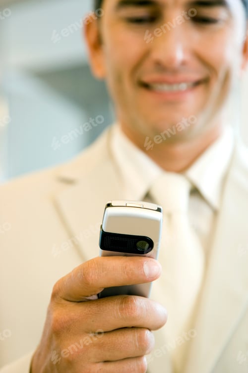 Preview: Businessman In A Light Suit, Using A Mobile Telephone