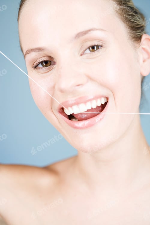 Preview: A Young Woman Flossing Her Teeth