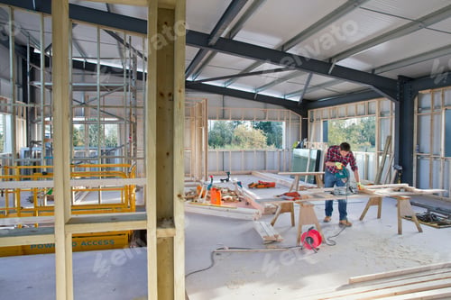 Preview: Building Construction Site Interior With Carpenter Working In Background