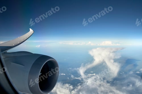 Preview: Aircraft Turbo Prop Jet Engine And Wingtip In Flight With Blue Sky And White Cumulonimbus Clouds