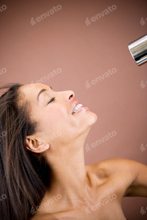 Preview: A Young Woman Blow Drying Her Hair