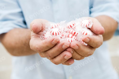 Preview: Senior Man'S Hand Holding Sweets Or Candy
