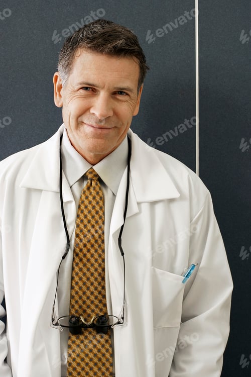 Preview: Vertical Shot Of A Male Dentist Wearing His Medical Coat.
