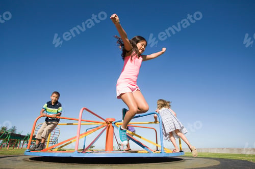 Preview: Children Playing On A Merry-Go-Round At A Playground