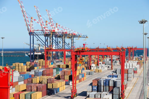 Preview: Wide Shot Of Cranes And Cargo Containers At A Commercial Dock With The Sea And Sky In The