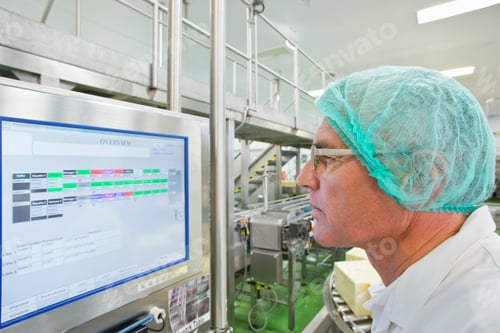 Preview: Machine Operator Watching Computer Monitor In Cheese Processing Plant