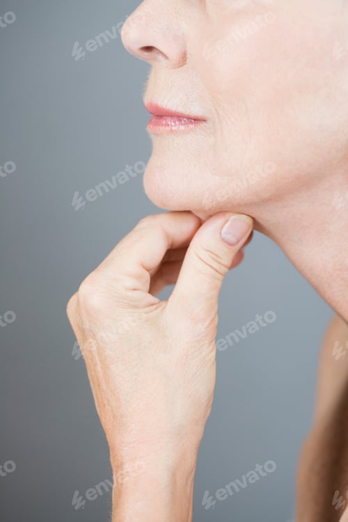 Preview: A Senior Woman Pinching The Skin Under Her Chin
