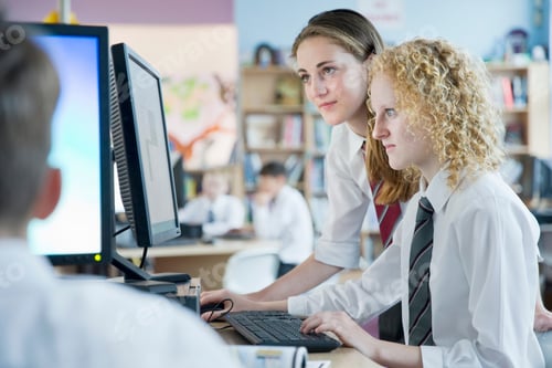 Preview: Focused Schoolgirls In Private School Uniform Sharing Computer In The Computer Lab