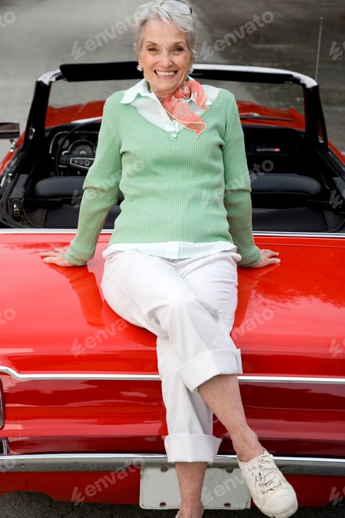 Preview: A Senior Woman Sitting On A Sports Car