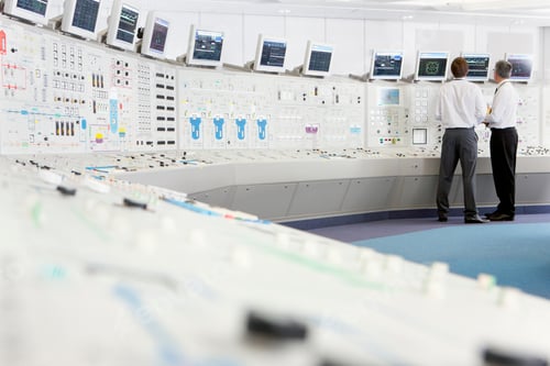 Vista previa: Wide Shot Of Two Engineers In A Control Room With Multiple Monitors At A Nuclear Power Station.
