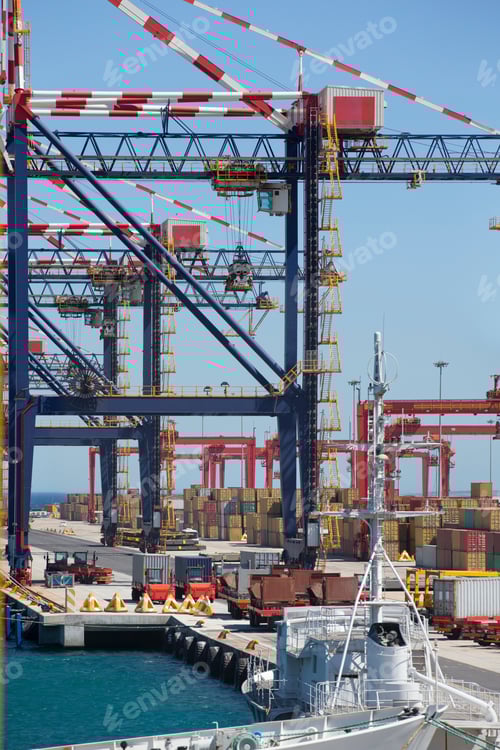 Preview: Vertical Wide Shot Of A Commercial Dock With Trucks, Cranes And Cargo Containers.