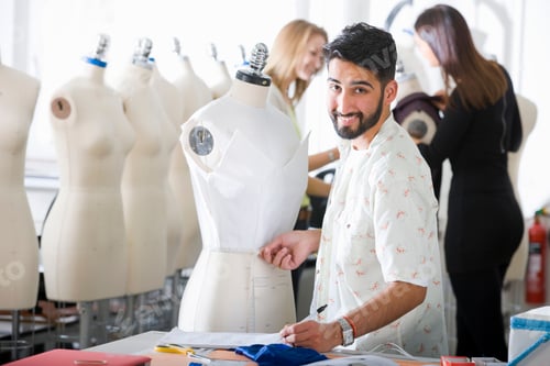 Preview: Medium Shot Of A Young Fashion Design Student Smiling At The Camera While Measuring A Garment Worn