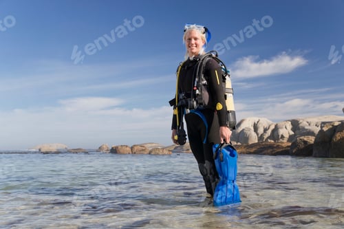 Preview: Woman In Wetsuit Going Ocean Scuba Diving From Beach And Smiling At Camera