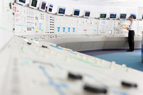 Preview: Senior Engineer Reading From A File In A Control Room At A Nuclear Power Station.