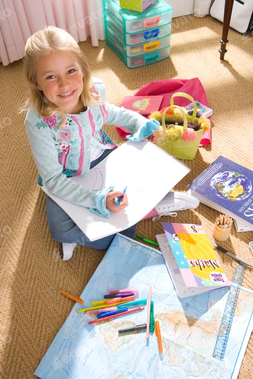 Preview: Smiling Girl Sitting On Floor In Bedroom Drawing At Camera