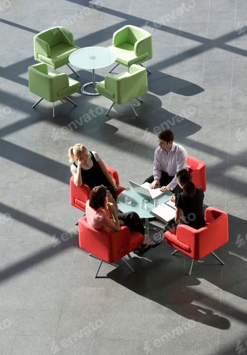 Preview: Four Business Colleagues Holding A Business Meeting