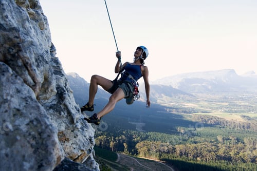 Preview: A Climber Abseiling On A Cliff
