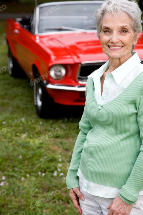Preview: A Senior Woman Standing By A Sports Car