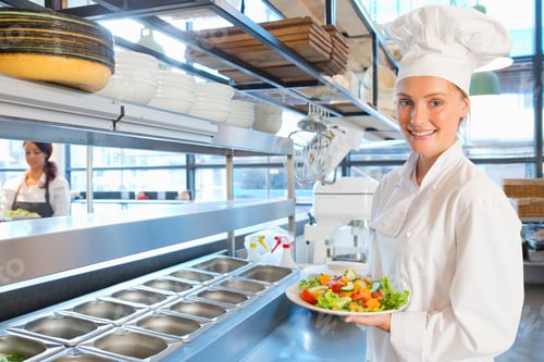 Preview: A Chef Standing With A Well Prepared Dish Of Salad