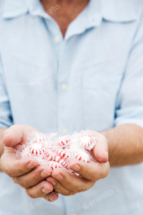 Preview: Senior Man'S Hand Holding Sweets Or Candy