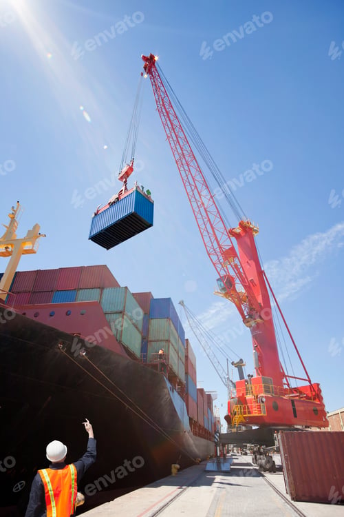 Preview: Vertical Shot Of Huge Crane Unloading Containers From The Cargo Ships And Placing Them On The Ground