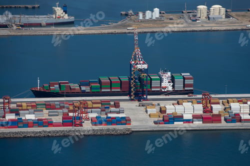 Preview: High-Angle Wide Shot Of The Side View Of A Container Ship Anchored At A Commercial Harbor.