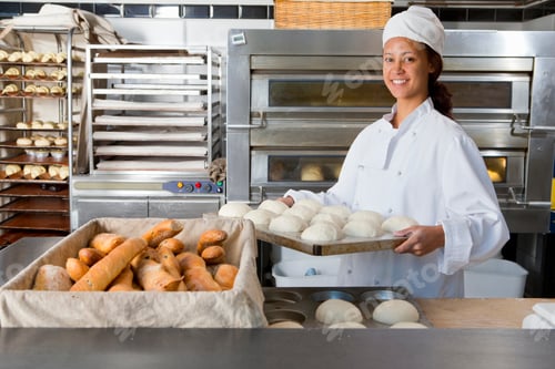 Preview: Young Baker Holding A Tray Of Molded Loafs Of Buns About To Be Baked