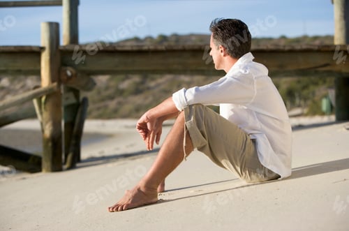 Preview: A Man Sitting On A Beach