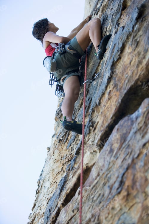 Preview: A Climber Climbing A Rock Face