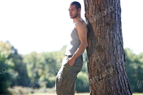 Preview: A Young Man Leaning Against A Tree, Thinking