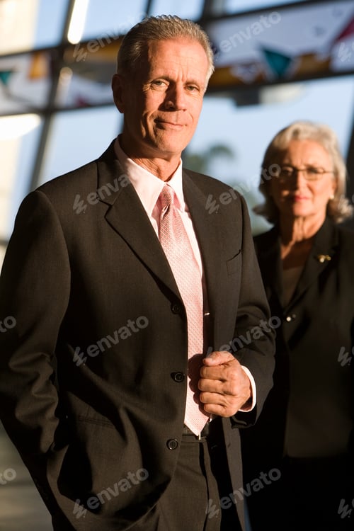 Preview: Portrait Of Senior Businessman And Businesswoman In Airport Building