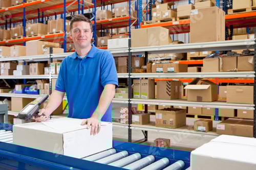 Preview: Medium Shot Of A Worker Smiling At The Camera While Scanning A Box At The Production Line Of A