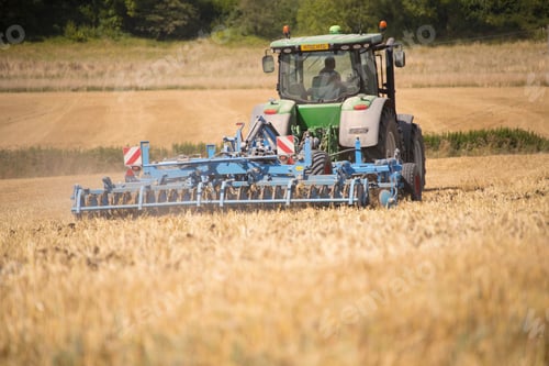 Preview: Rear View Of Tractor Ploughing Field Using Disc Plough
