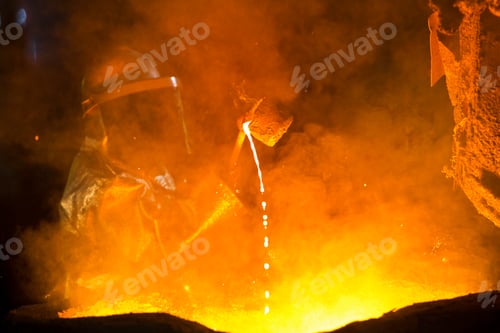 Preview: Worker In Protective Clothing Checking Molten Metal In Foundry