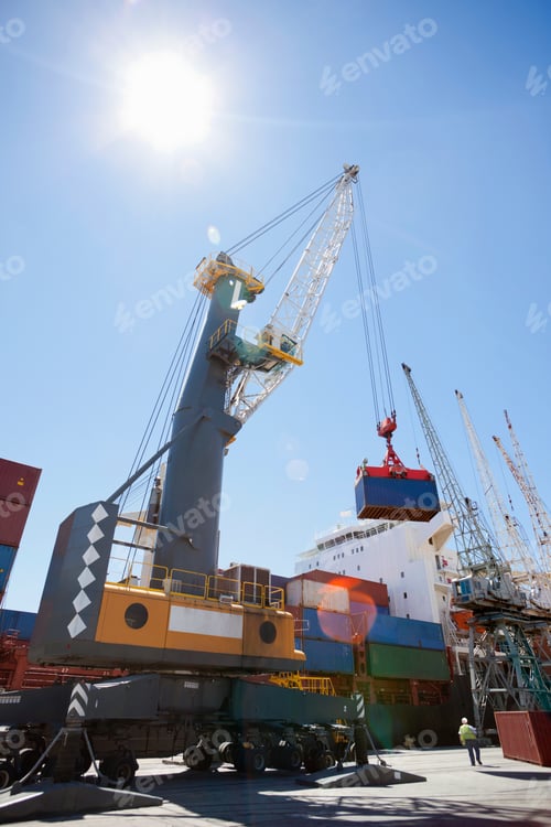 Preview: Low Angle Shot Of A Huge Crane Unloading Containers From The Ship