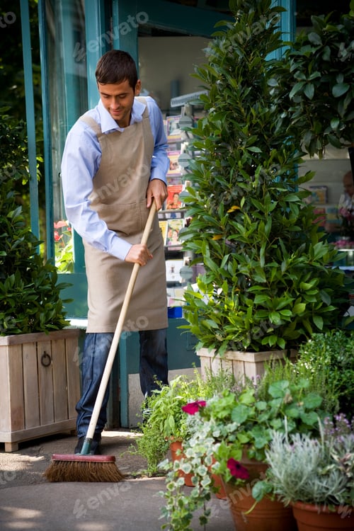 Preview: Male Florist Sweeping Up Outside His Shop