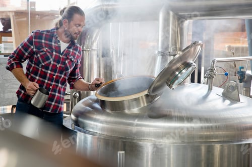 Preview: Brewery Worker Checking Fermentation Process In Steel Vat
