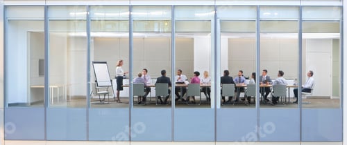Preview: Wide Shot Through An Office Window With A Businesswoman In A Meeting With Her Employees.