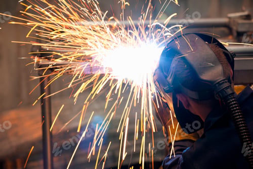 Preview: Welder Using Welding Saw To Work On A Metal Object In A Factory